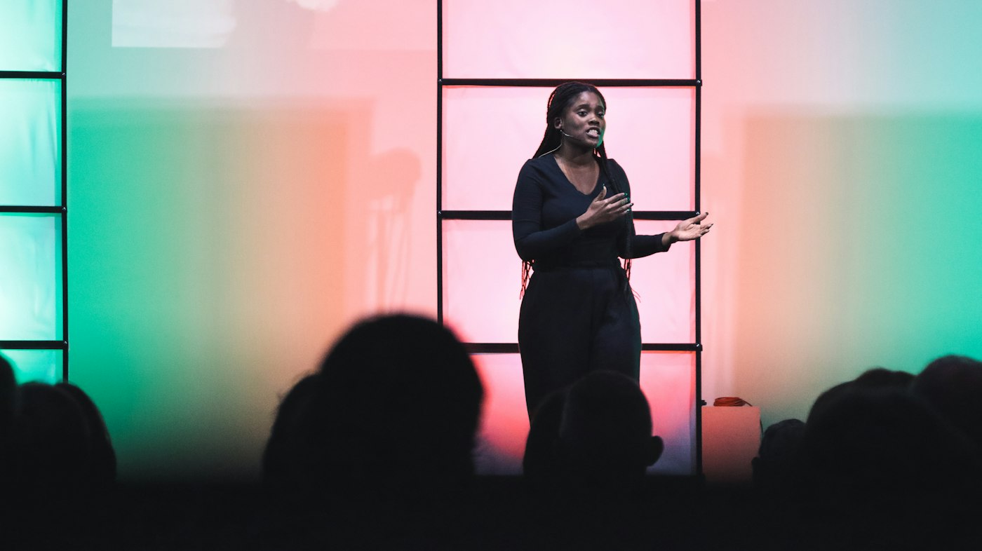 Speaker on stage presenting at a launch event