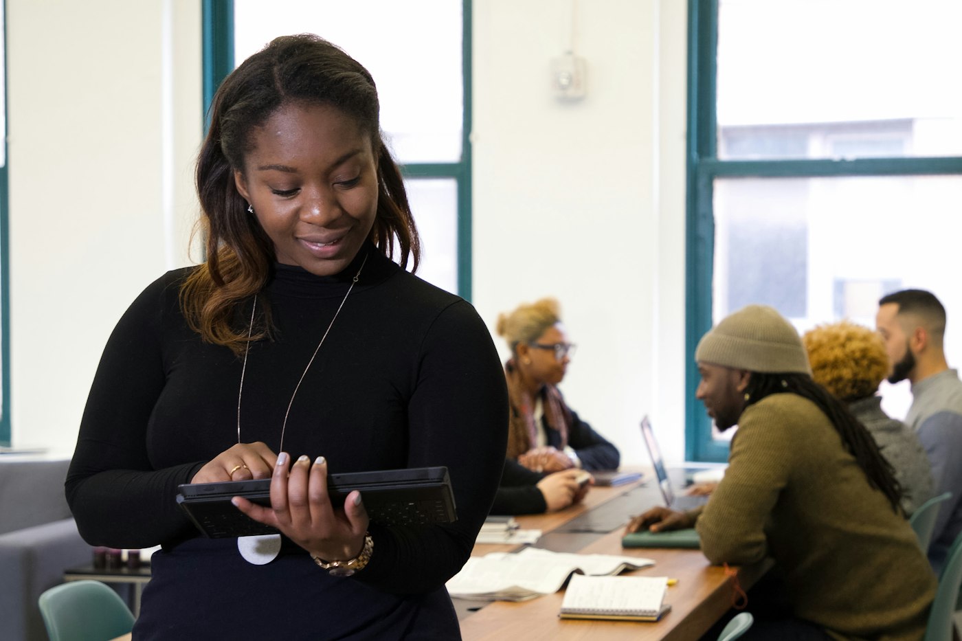 Account lead holding a tablet in the agency office
