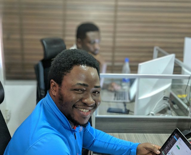 Staff member smiling at his laptop