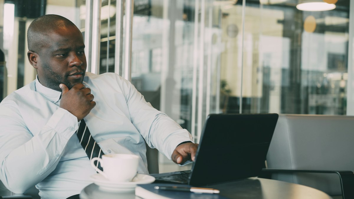 Accountant reviewing supplier bills on his laptop