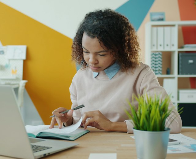 Finance lead working through figures in a notebook