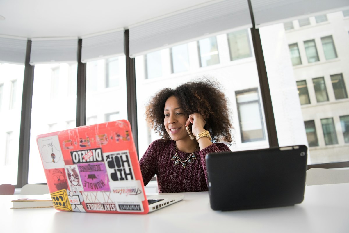 Finance officer on a call while checking payments on her laptop