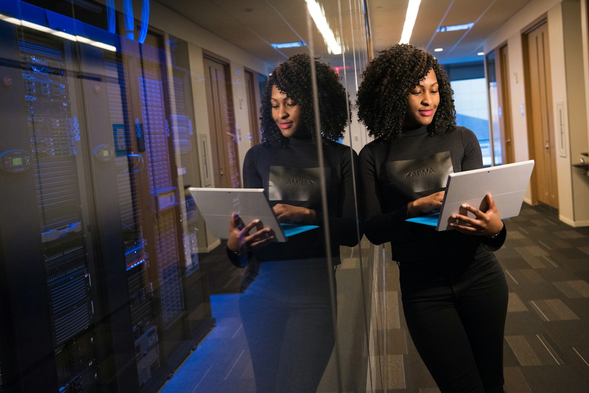 Two finance professionals reviewing figures on tablets