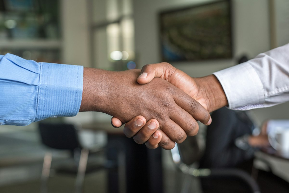 Client and contractor shaking hands on an approved estimate