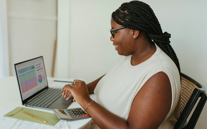Accountant working with a calculator and laptop