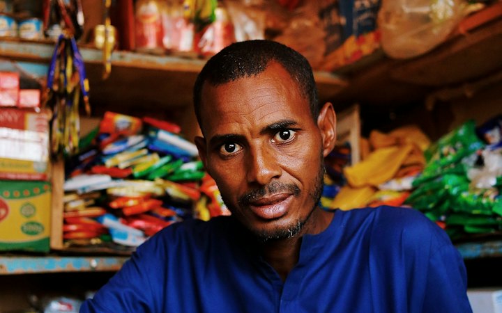 Shop owner standing in his store