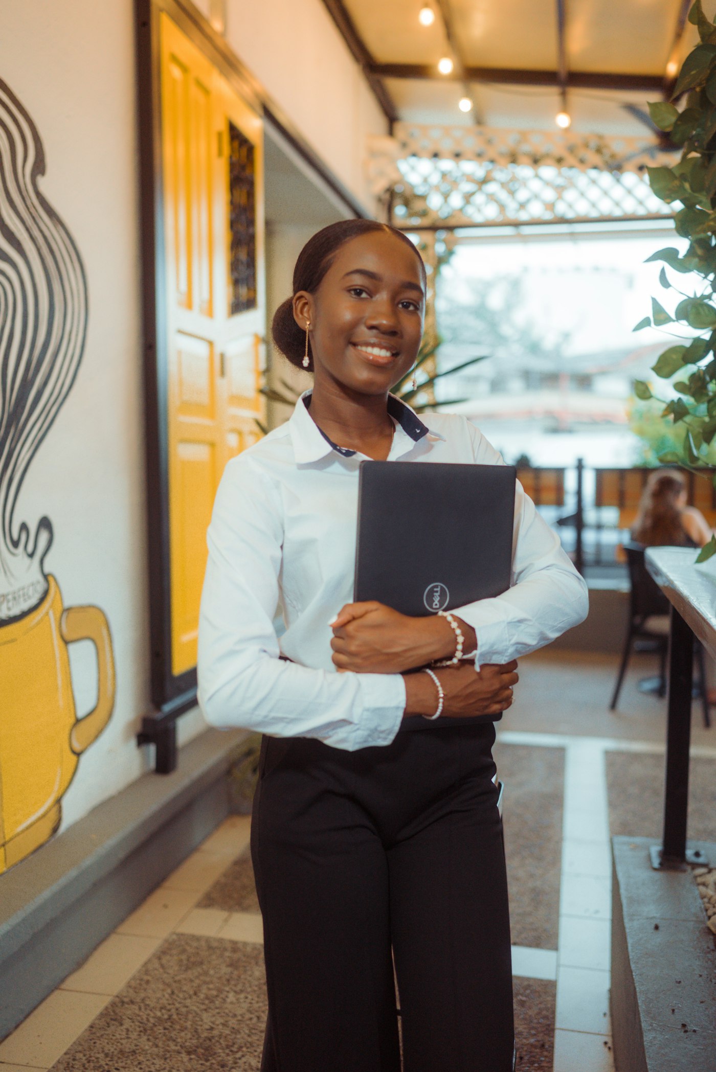 Restaurant manager in a white shirt holding a folder