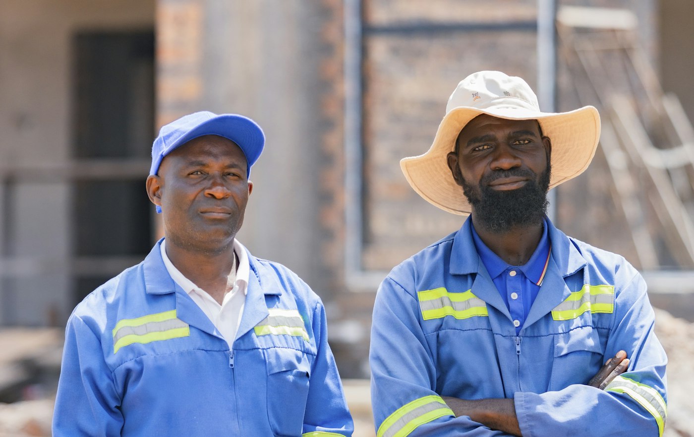 Two factory workers in blue work uniforms