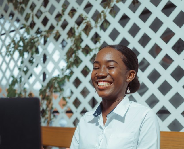 Procurement officer smiling at her laptop