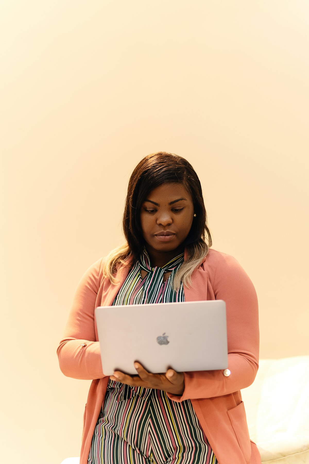 Procurement manager setting up purchase order rules on her laptop