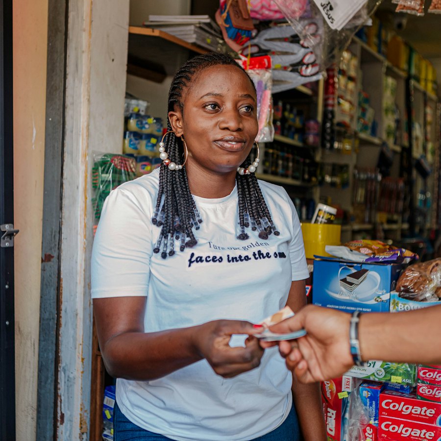 Shop owner taking payment from a customer at her counter