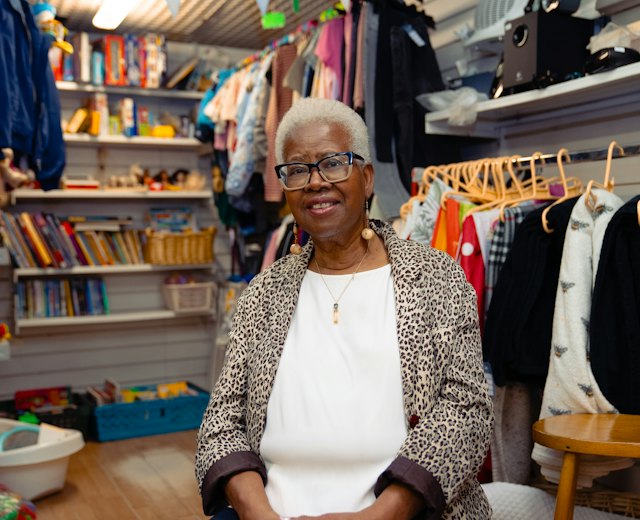 Shop owner smiling in her clothing store