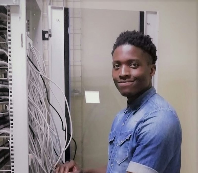 Network technician working at an equipment cabinet