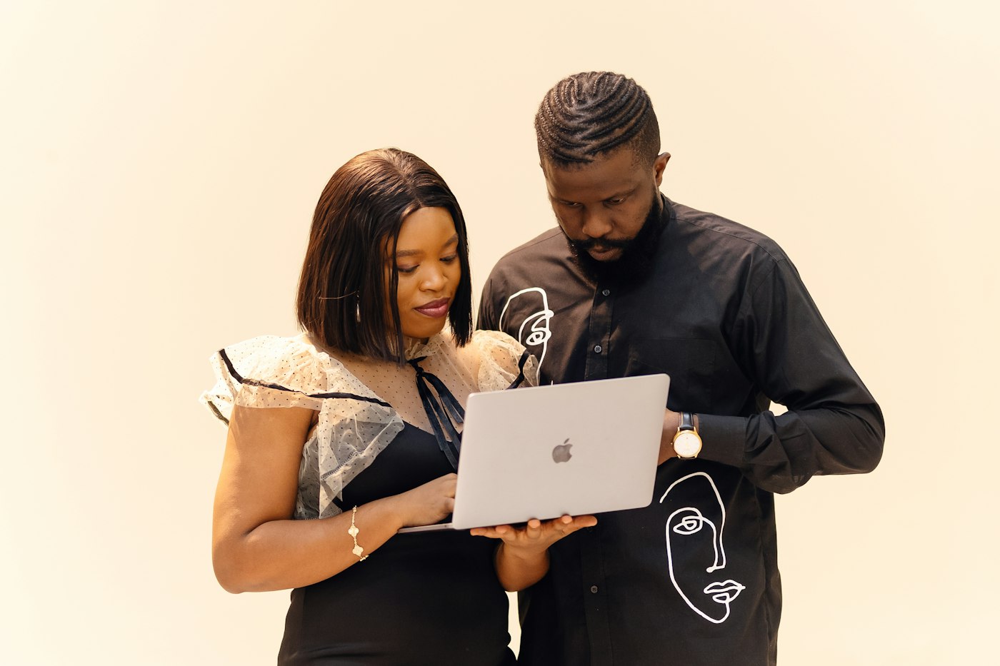 Two consultants reviewing work together on a laptop