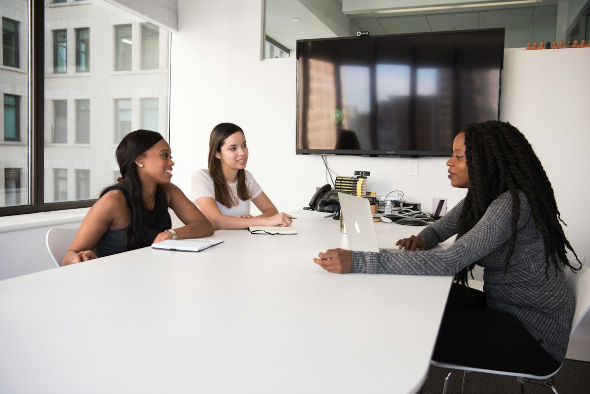 Procurement team discussing requests around a meeting table