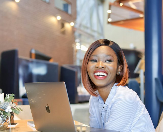 Finance manager smiling at her laptop