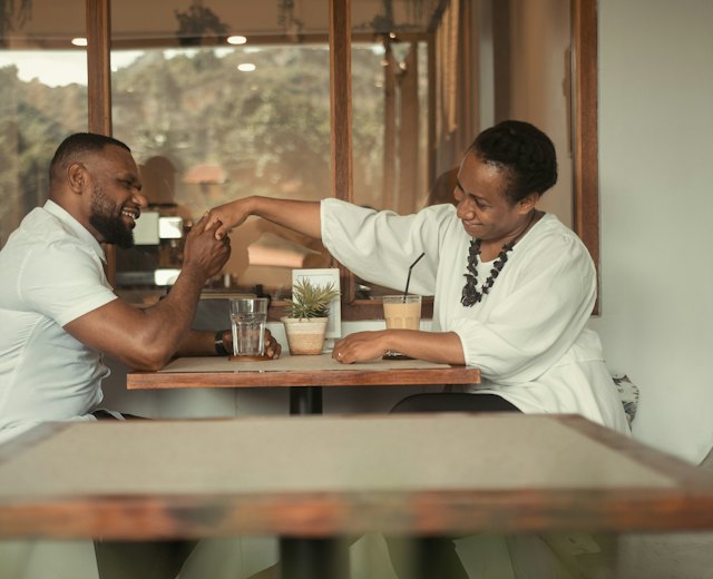 Business owner talking with her partner at a cafe table