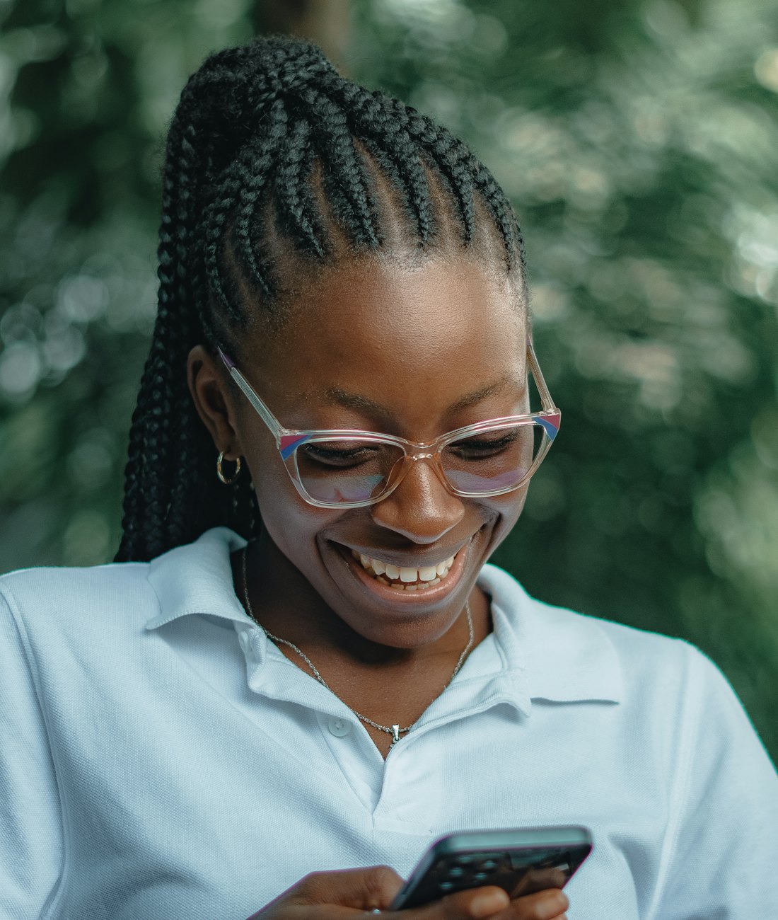 Business owner smiling at a payment notification on her phone